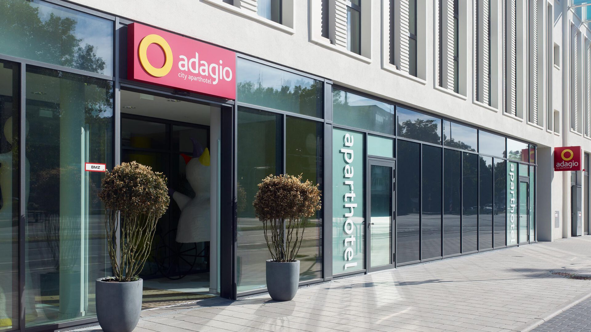 Eingangsbereich mit dem Schriftzug aparthotel auf der Glasfassade