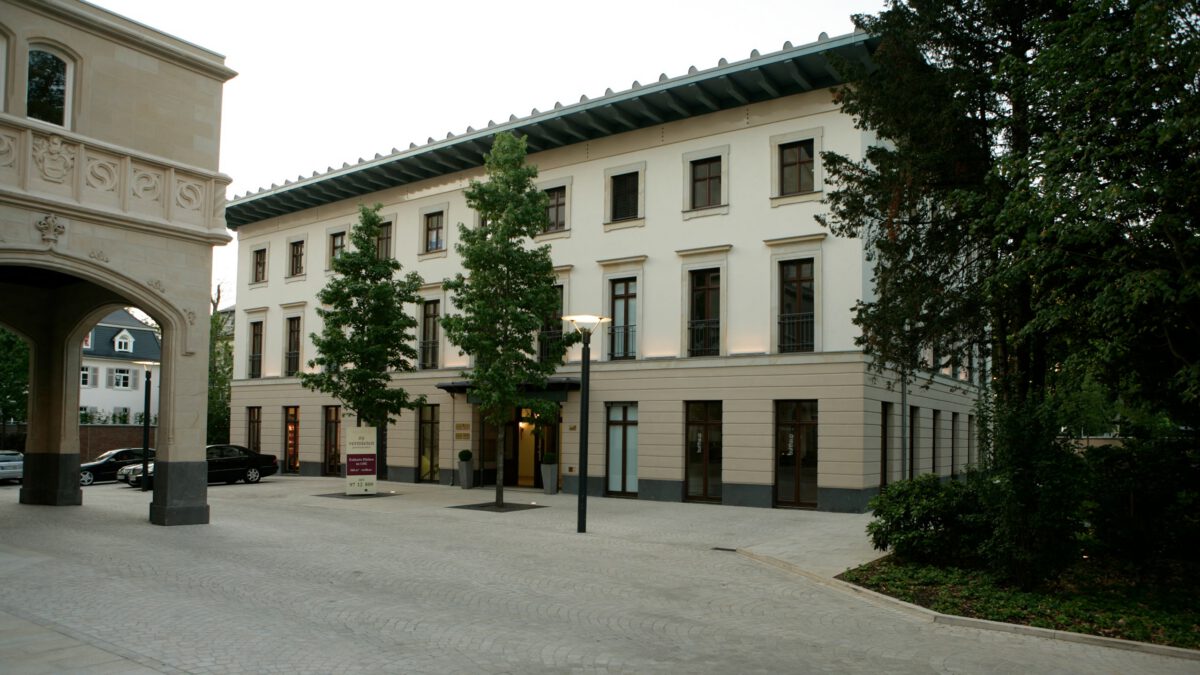 Palais 22 in Frankfurt am Main, der beleuchtete Innenhof am Abend mit dem Torbogen rechts