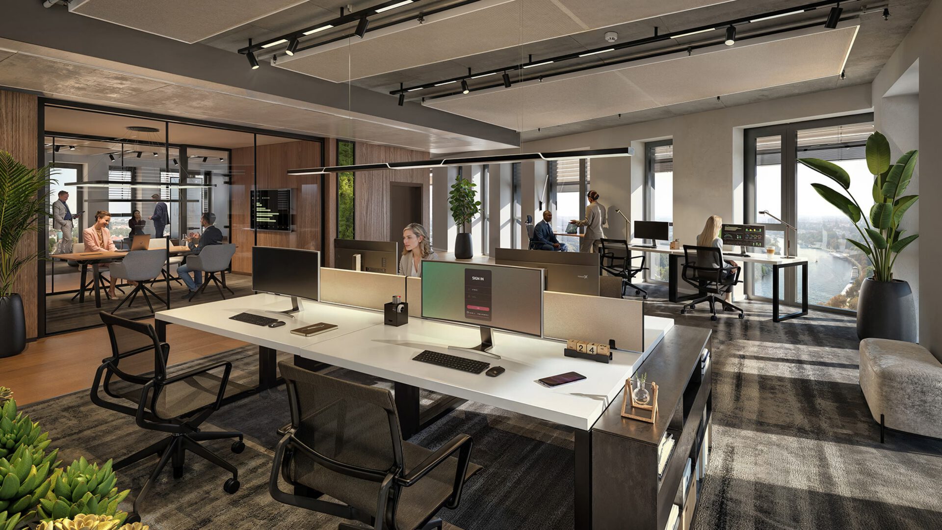 Bürofläche mit Doppelarbeitsplätzen, Monitoren und angrenzendem Besprechungsraum hinter Glas