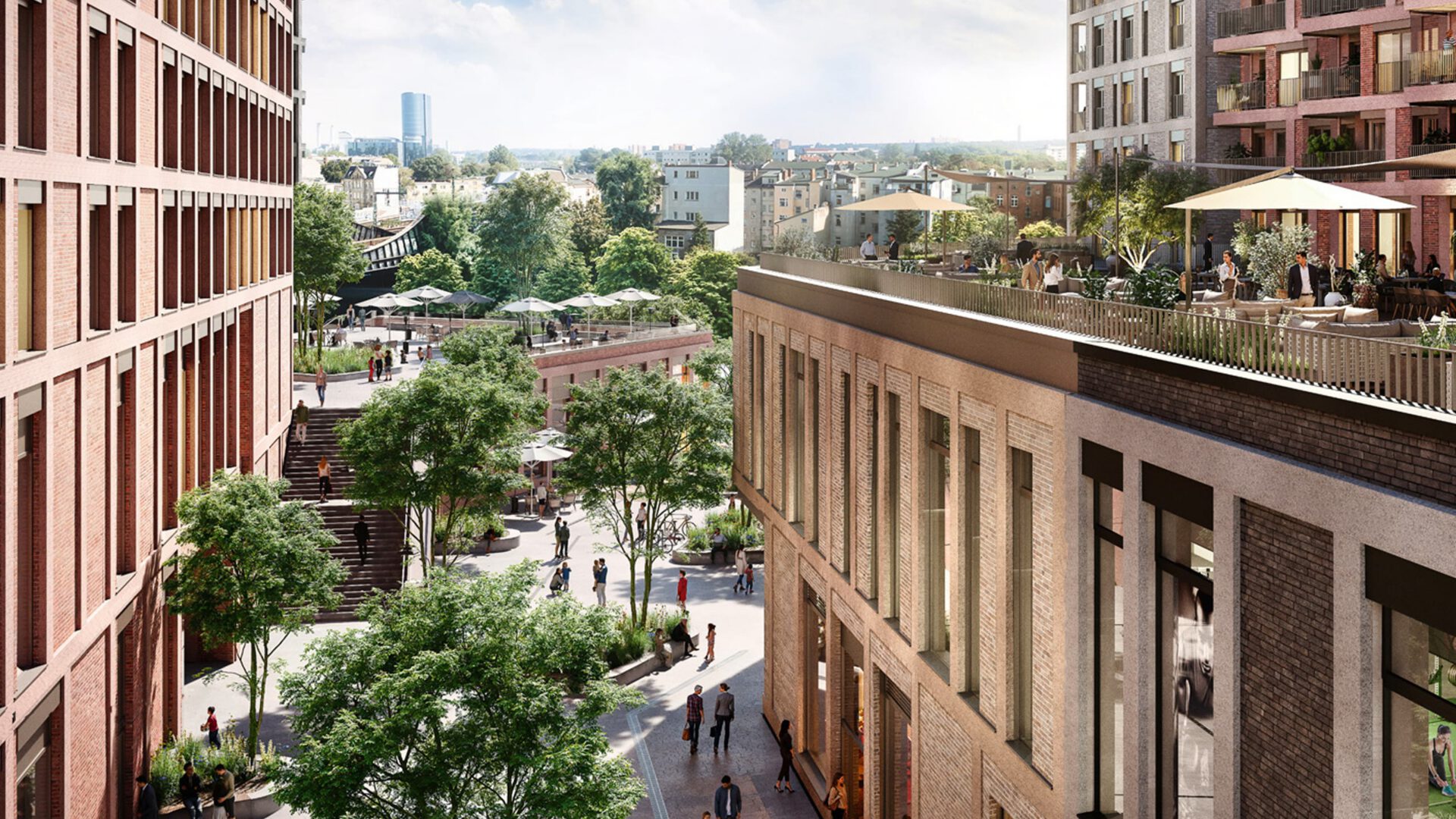 Blick von oben in die Quartiersstraße, rechts eine Dachterrasse über der Ladenzeile